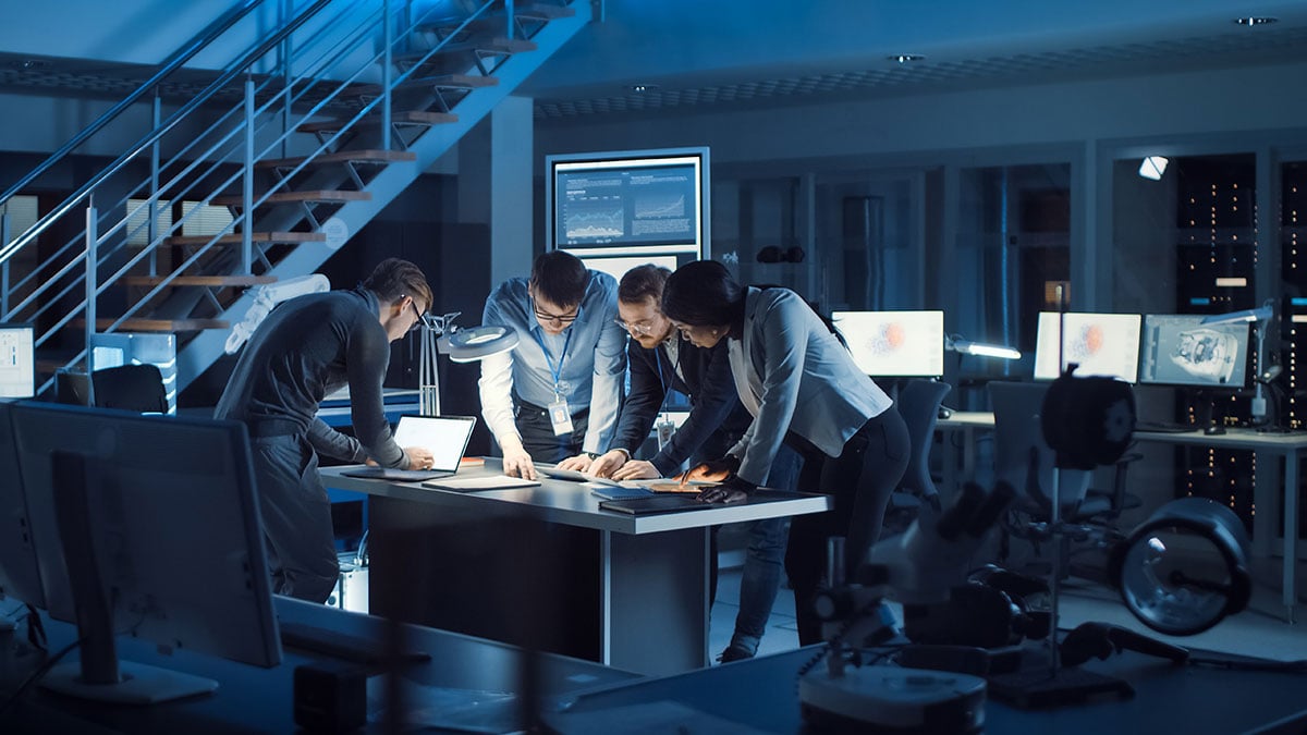 Team of Electronics Development Engineers Standing at the Desk